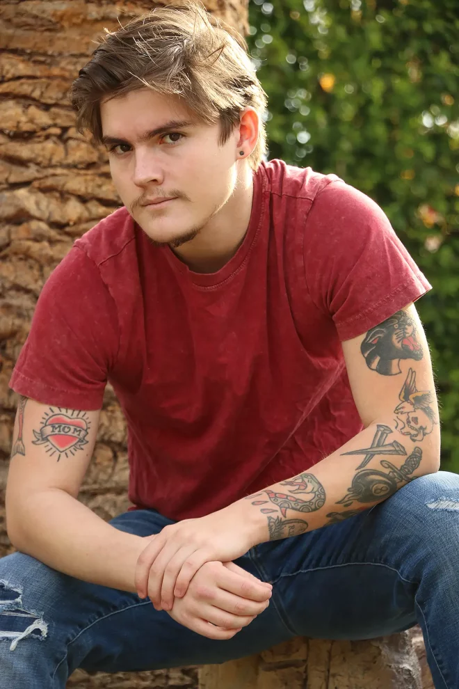 Pornstar Tyler Cruise posing in red t-shirt